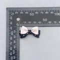 Detail view of a 4cm double-layered polka dot and pink satin bow DIY accessory - Pink Black Polka Dot Trim (80)