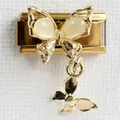 Detail of golden stainless steel butterfly charm with cream resin inlay and small pendant - Double Butterfly Gold Butterfly Gold Style