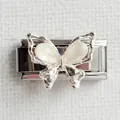 Macro view of silver butterfly charm with white opal stones on stainless steel link - Butterfly Silver Style 1