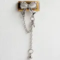 Detailed close-up of a stainless steel butterfly charm with dangling cross chains - White Zirconia Silver Chain Gold Style