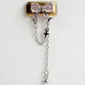 Macro detail of Italian charm link with pink butterfly and silver tassel star charms - Pink Zirconia Silver Chain Gold Style