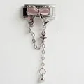 Macro detail of Italian charm bracelet link with pink bow and dangling cross pendant - Pink Zirconia Silver Chain Silver Style