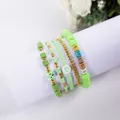 Green bohemian beaded bracelet set featuring Lucky letters, heart bead, and bear charm - Lucky Grass Green