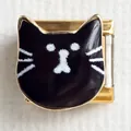 Macro view of modular Italian charm with a black enamel cat design on gold stainless steel - Black Cat