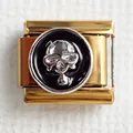 Macro detail of Italian charm link featuring a silver skull relief on a black background - Skull