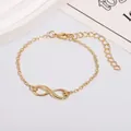 Classic gold infinity bracelet with adjustable chain and lobster clasp on white background - Gold