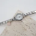Dettaglio dell'orologio al quarzo argento con cinturino a ciondoli e pendente a conchiglia - Quadrante Bianco Pendaglio Conchiglia