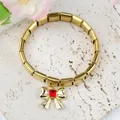 Gold Italian charm bracelet with a bow pendant featuring a square red gemstone inlay - Gold Red Zircon