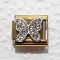 Macro detail of a gold Italian charm link featuring a silver pave butterfly with crystals - Diamond Butterfly