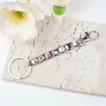 Italian charm keychain with stainless steel links and colorful cartoon charms on a stone slab - Cartoon Girl Theme