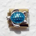 Macro detail of Italian modular charm with golden base and blue enamel sea turtle design - Turtle