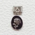 Macro detail of Italian charm bracelet link with black enamel and silver floral pendant - Flower Black / Silver Black