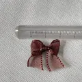 Detail view of a 2.5cm dark brown organza bow accessory with sheer texture and fine edges - Dark Brown