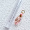 Macro shot of 2.5cm pink teardrop acrylic pendant with gold metal ring and bead - Pink Striped Teardrop Pendant (1)