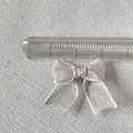 Close-up of a 2.5cm silver organza mini bow accessory with a ruler for size measurement - Silver Gray