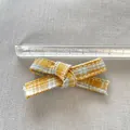 Macro detail of a 7.5cm yellow and blue plaid bow with white stitching for DIY crafts - Yellow Blue Small Plaid