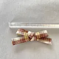 Detail shot of a 7.2cm plaid ribbon bow for DIY doll clothes with a measuring ruler - Brown Yellow and White Plaid