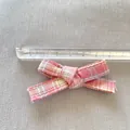 Detailed view showing a pink plaid bow being measured with a ruler at 5 cm - Pink Plaid