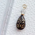 Detailansicht des handgefertigten Acryl-Anhängers mit Goldmuster und Maßstablineal - Schwarzer Tropfenanhänger mit Blumenmuster (8)