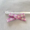 Detail view of a purple plaid bow accessory measured with a ruler showing 7cm length - Purple Plaid