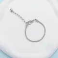 Polished silver snake bone chain bracelet with heart charm and lobster clasp closure - 16cm