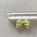 Close-up of a 1.8cm light green ribbon bow accessory for DIY crafts and nail art design - Light Green
