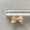 Macro shot of a 2.5cm champagne organza ribbon bow for DIY nail art and craft accessories - Champagne Mesh