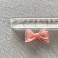 Close-up of a 2cm pink organza bow charm with a ruler showing exact size measurement - Pink Mesh