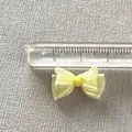 Macro detail of 2cm light yellow organza bow accessory with fine mesh texture and ruler - Light Yellow