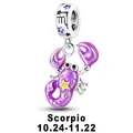 Macro detail of Scorpio zodiac charm with purple enamel and engraved silver bail - Scorpio