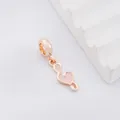 Detailed macro view of rose gold musical note charm with pink enamel heart detail - Rose Gold