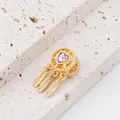 Macro detail of a golden dreamcatcher bead with pink heart crystal and three feathers - Gold Dreamcatcher Pink Heart