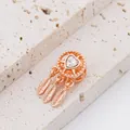 Macro view of rose gold dreamcatcher charm with heart cubic zirconia and three feathers - Rose Gold Dreamcatcher Clear Heart