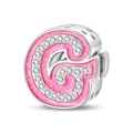 Macro detail of pink glitter letter G charm with zircon pavé and hollow hearts - Letter G