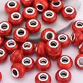 Macro detail of 14mm red cracked resin beads with silver large hole metal core inserts - Red