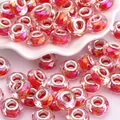 Macro view of faceted resin beads with silver metal core on white ceramic tray - Deep Rose and Orange (1)