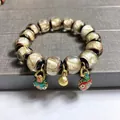 Detailed macro shot of vintage glass beads with gold foil and colorful lucky bag charms - White