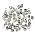 Detailed close-up of retro silver alloy charms with intricate heart and floral patterns - 50 Pieces Set / White