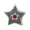 Macro shot of silver star charm with black dotted texture and centered red rhinestone - Pentagram Polka Dot Bead