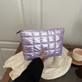 Lavender quilted waterproof clutch bag with metallic glossy finish and black zipper - Purple