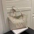 Minimalist beige tote bag with M letter prints and gold rivets on decorative book - White Without Pendant
