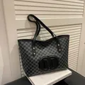 Chic grey monogram canvas tote bag featuring large black leather M logo and leather straps - Black without Pendant