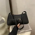 Minimalist black faux leather shoulder bag with gold buckle and adjustable strap - Black