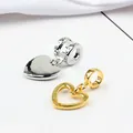 Macro shot of gold hollow and silver solid heart pendants for DIY bracelet making - Gold and Silver Set
