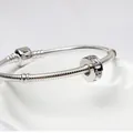 Silver snake chain bracelet with sparkling crystal charm spacer and barrel clasp closure - White