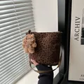 Leopard print bucket bag with brown leather strap and plush dog keychain detail - With Plush Charm / Brown