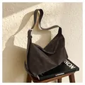 Close-up of a dark coffee brown suede-textured hobo bag with adjustable silver buckle - Brown