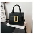 Chic black matte leather tote bag with large matte gold buckle and detachable strap - Black