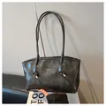 Dark charcoal grey retro tote bag with long knotted straps and gold metal hardware - Dark Gray