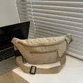 Close-up of beige corduroy waist bag with metal zippers on a white desktop setup - Khaki
